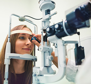 A patient using Ophthalmology equipment for an eye examination.