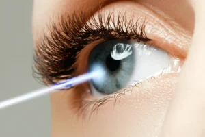 Image of an eye with a laser beam directed into the eye